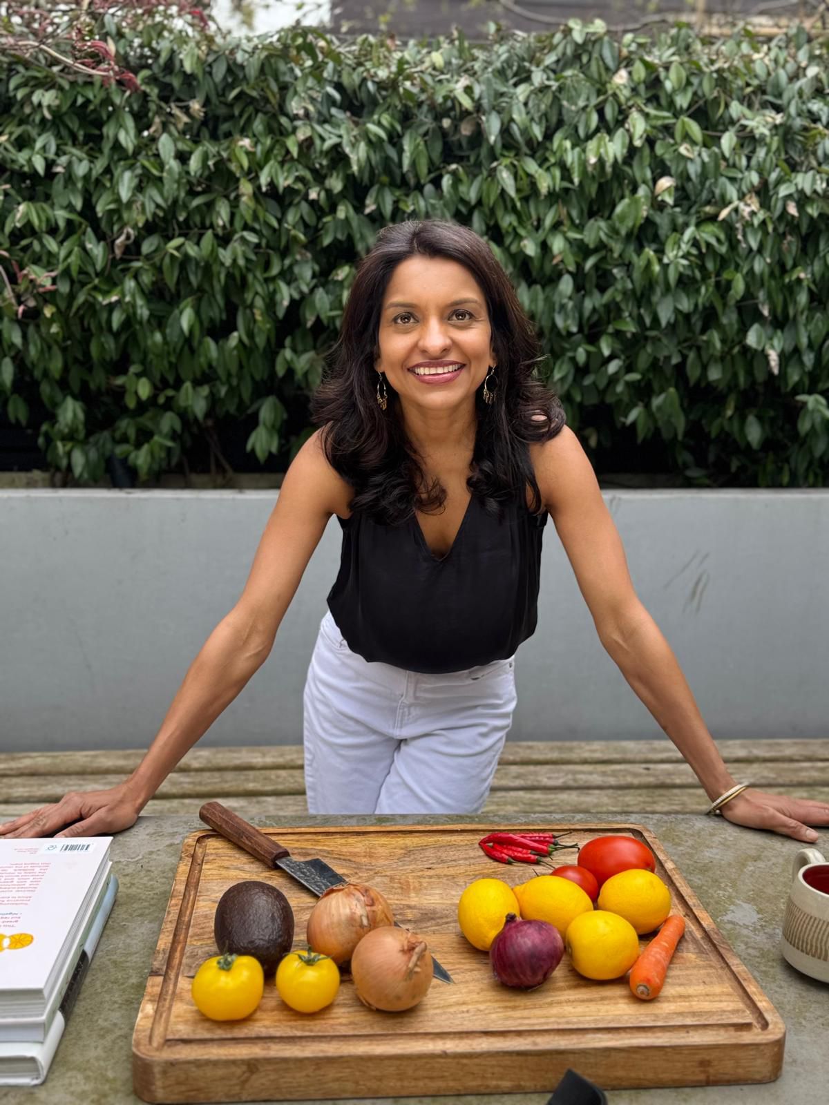Sabina in the garden with fresh ingredients on a chopping board